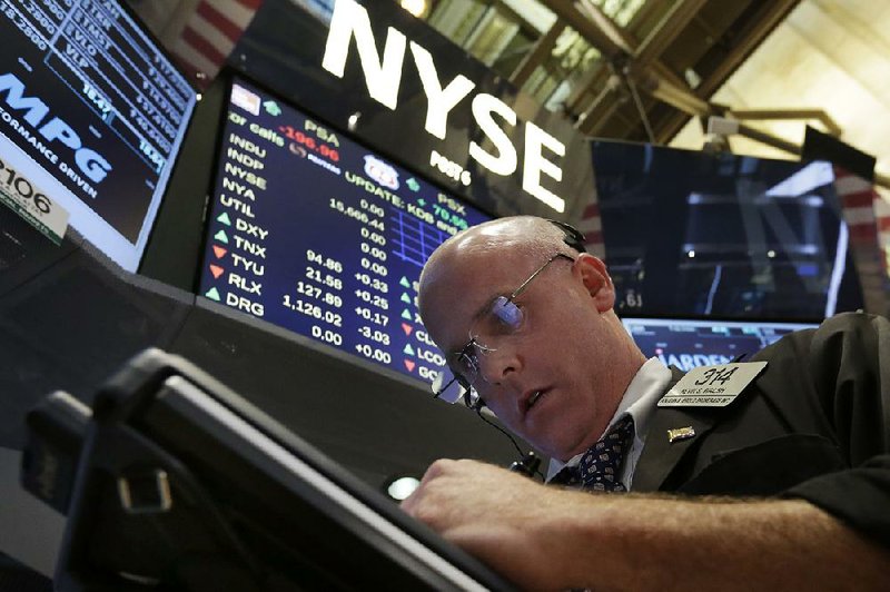 Trader Kevin Walsh works to keep up with the activity Wednesday on the floor of the New York Stock Exchange.
