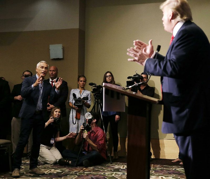 Univision newsman Jorge Ramos at a news conference Tuesday in Dubuque, Iowa, questions Donald Trump about his immigration proposal, leading Trump to have Ramos escorted out.