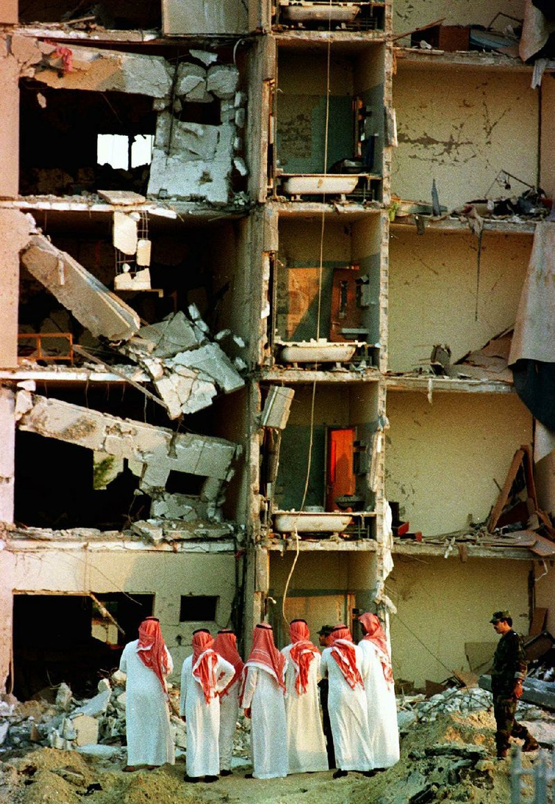 In this June 27, 1996, photo, Saudi officials investigate at the bomb-damaged Khobar Towers apartments at the U.S. military base in Dhahran, where 19 Americans were killed.