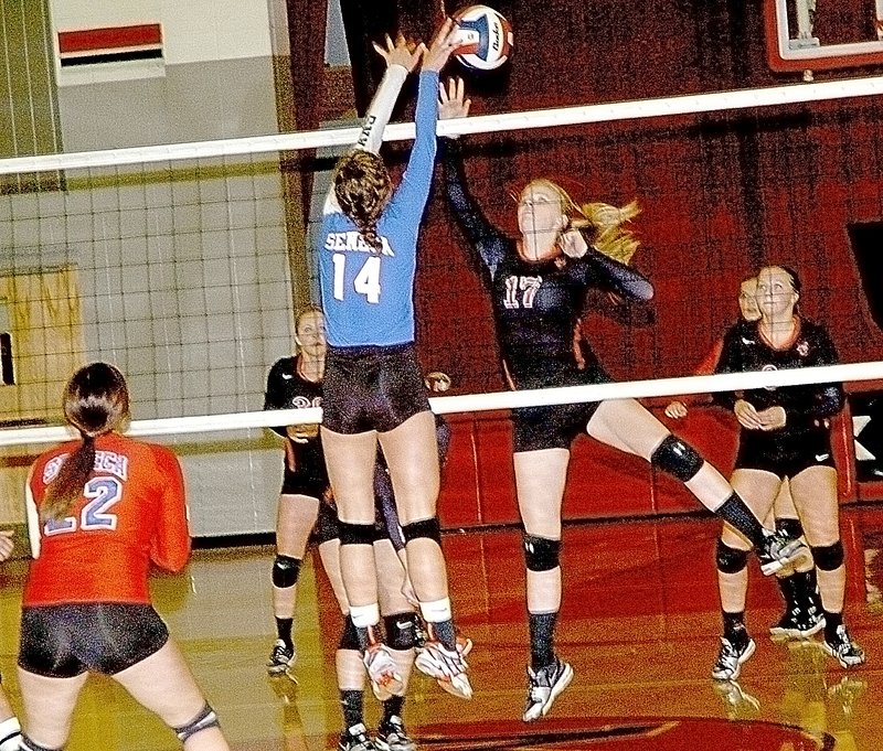 PHOTO BY RICK PECK McDonald County&#8217;s Bailey Rickett (17) and Seneca&#8217;s Morgan Henning (14) battle for control of the ball at the net during the Lady Mustangs&#8217; 15-6, 15-11 win in a scrimmage held Aug. 18 at MCHS.