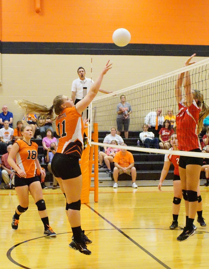 Amanda Pinter, with her sister Stephanie in the background, puts one over the net against Farmington on Aug. 25 at Gravette. The Lady Lions lost the pre-season game in three straight sets - 25-19, 25-15 and 25-18. The new Gravette coach, Katie Collins, said her team would use the game as an opportunity to learn and improve.