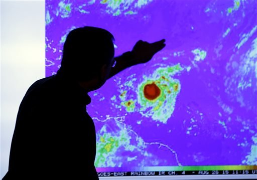 James Franklin, chief hurricane forecaster, looks at an image of Tropical Storm Erika on Wednesday, Aug. 26, 2015, as it moves westward toward islands in the eastern Caribbean, at the National Hurricane Center in Miami. 