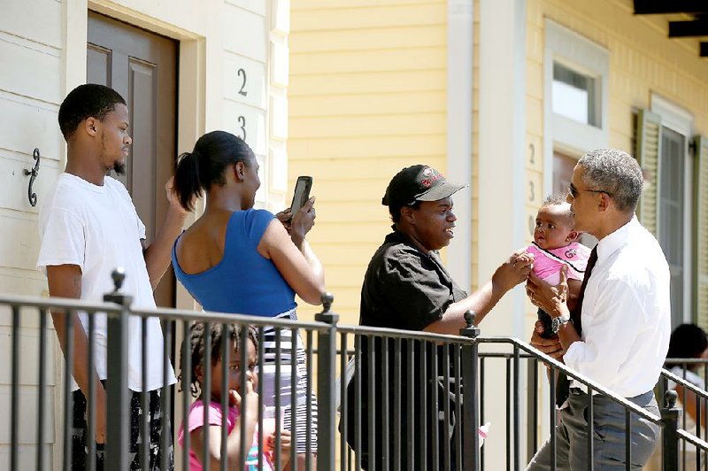 President Barack Obama meets residents Thursday in the Treme neighborhood of New Orleans on the 10th anniversary of the city’s devastation by Hurricane Katrina.