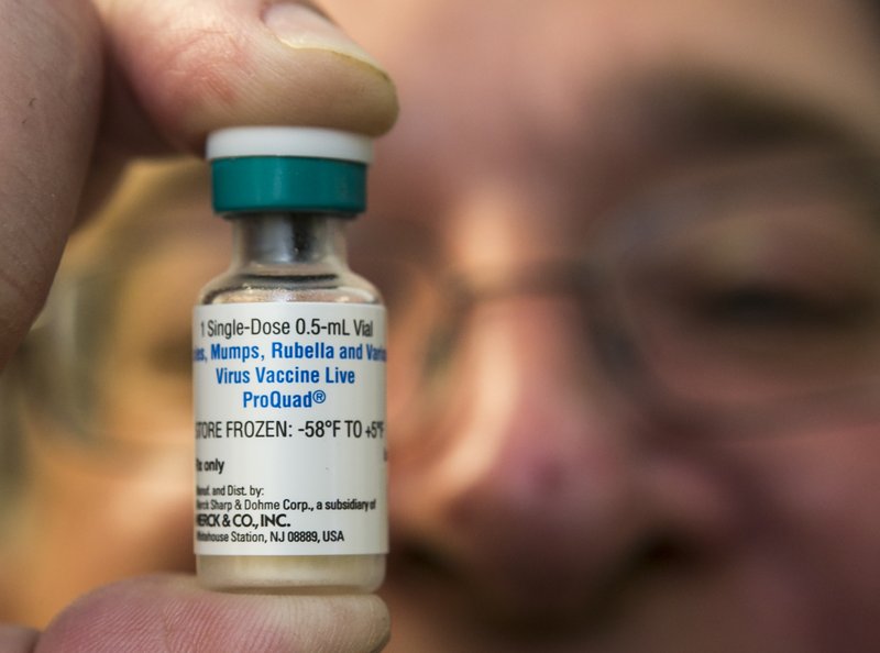 The Associated Press MORE DATA AVAILABLE: A pediatrician holds a dose of the measles-mumps-rubella (MMR) vaccine at his practice in Northridge, Calif. In 2014, only 21 states posted vaccination rates for individual schools, school districts, counties or areas of the state.