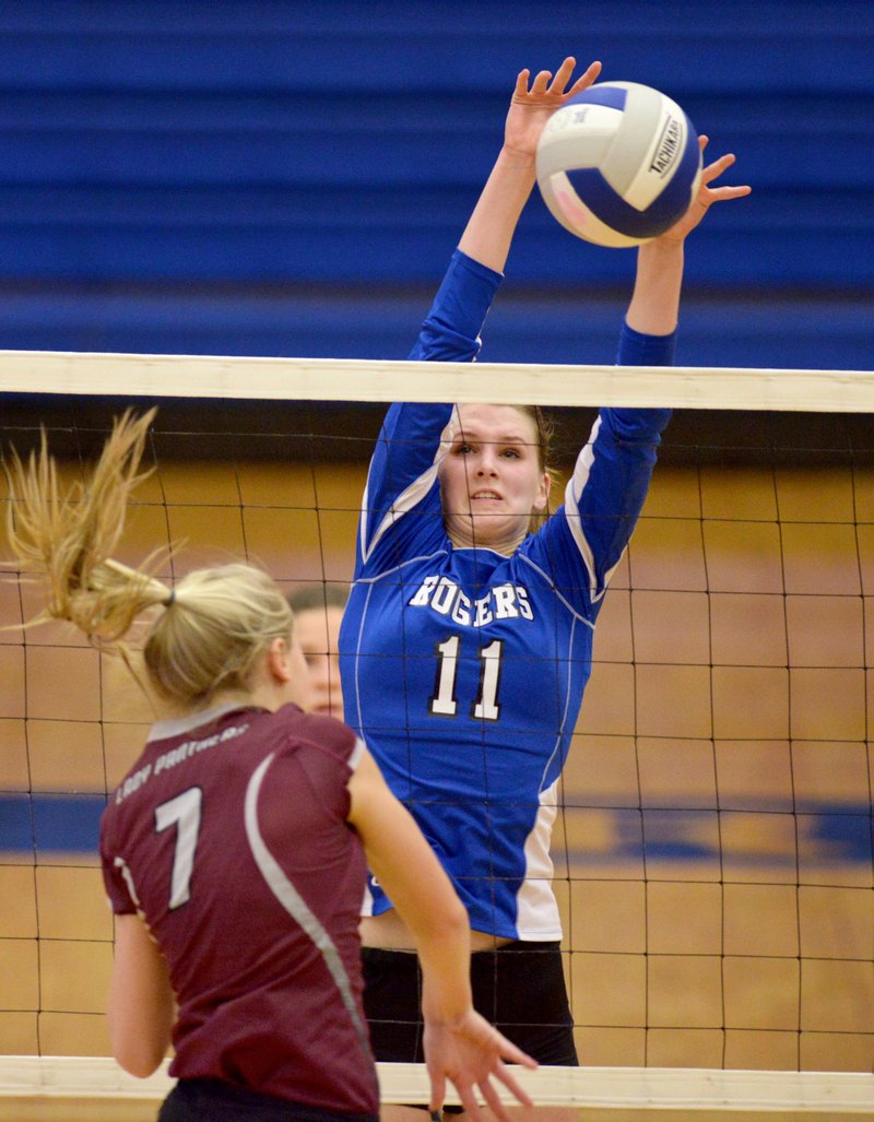 Hannah Martin (11) of Rogers High blocks a ball Thursday hit by Shaylon Sharp (7) of Siloam Springs during the match at Rogers High.