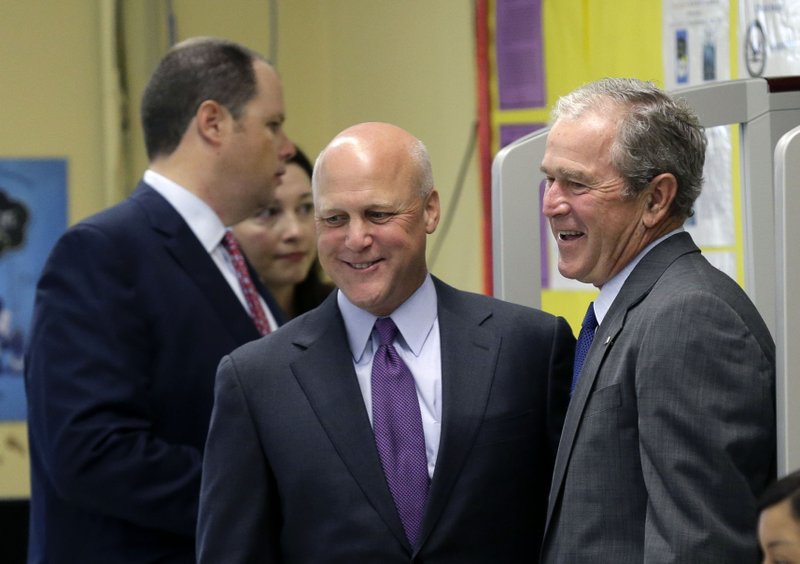 Former President George W. Bush, right, laughs with New Orleans Mayor Mitch Landrieu as they enter a roundtable discussion on education at Warren Easton Charter High School in New Orleans, Friday, Aug. 28, 2015. Bush is in town to commemorate the 10th anniversary of Hurricane Katrina, which is Saturday.
