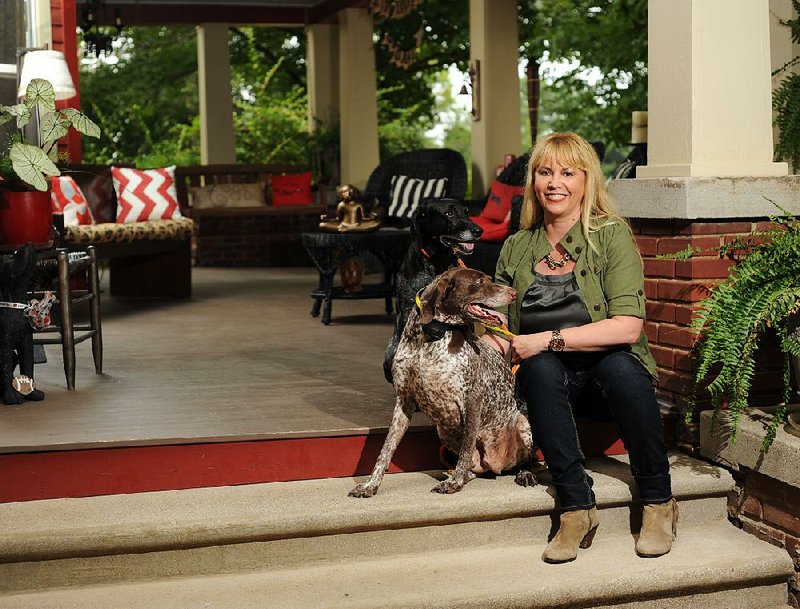 Amy White's favorite place is the front porch of her historic University Heights home in Fayetteville which she shares with her dogs Harper (back) and Natalie.