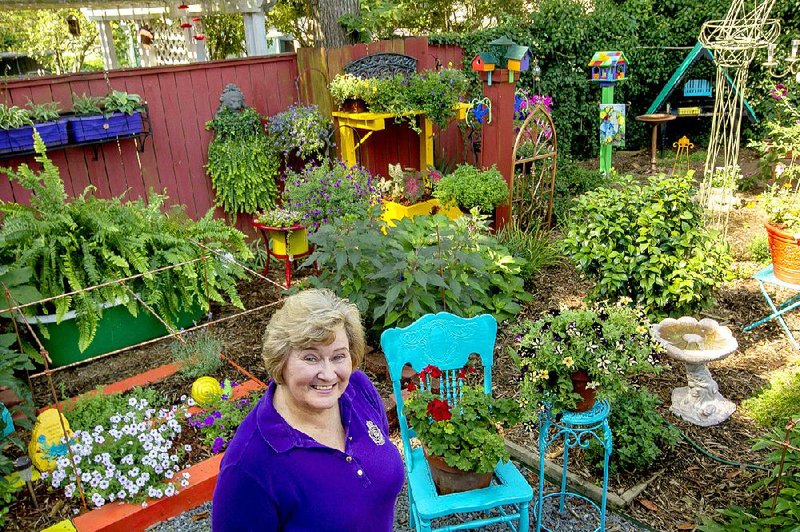 Sandra R. Wilson is shown in her backyard flower garden in Quapaw Quarter.