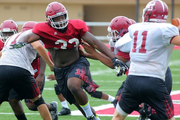 Hope defensive end McTelvin Agim crashes through the line in pursuit of the quarterback during practice. 