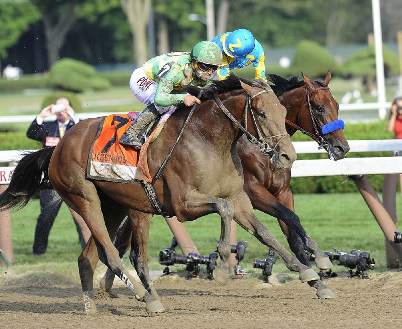 Keen Ice (7), ridden by Javier Castellano, moves past Triple Crown winner American Pharoah and jockey Victor Espinoza to win the Travers Stakes at Saratoga Race Course on Saturday.