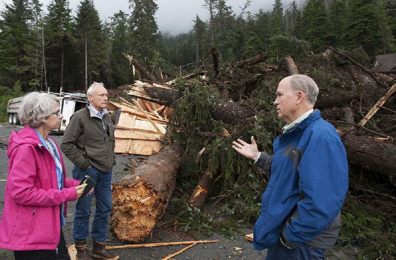 Alaskan Gov. Bill Walker (right) visits the site of a landslide this month. Walker and U.S. Sen. Lisa Murkowski, R-Alaska, are among Alaskan politicians wary of what President Barack Obama will or won’t announce during his tour of their state this week.