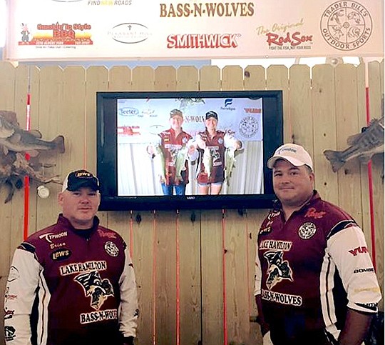 Submitted photo Bass-n-Wolves Coaches Brian Hopkins, left, and Greg Mundy take a break at the Lake Hamilton booth at the FLW Expo. The fishing team ran a booth and assisted with the weigh-in of the FLW Forrest Wood Cup Fishing Championship.