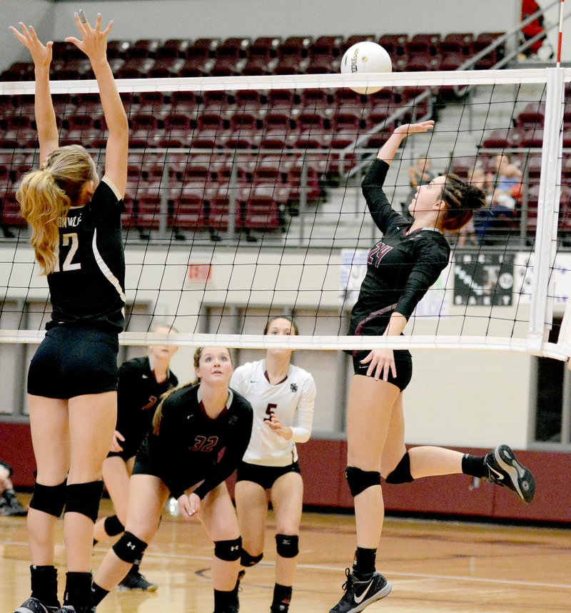 Bud Sullins/Special to Siloam Sunday Siloam Springs senior Krysten Hall, right, goes in for a hit while Bentonville sophomore Tymber Riley, left, attempts to block Tuesday during a nonconference volleyball match. Bentonville swept the match 3-0.