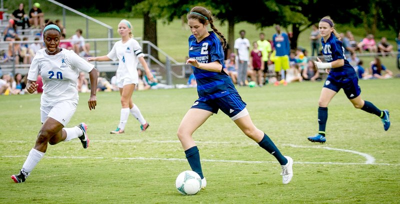 Photo courtesy of Tom Harris JBU freshman Jastin Redman, dribbles the ball through the Central Baptist College defense during Friday&#8217;s game at Alumni Field.