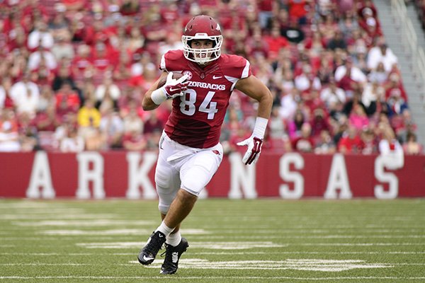 In this photo taken Sept. 6, 2014, Arkansas tight end Hunter Henry carries in the first half of an NCAA college football game in Fayetteville, Ark. (AP Photo/Sarah Bentham)