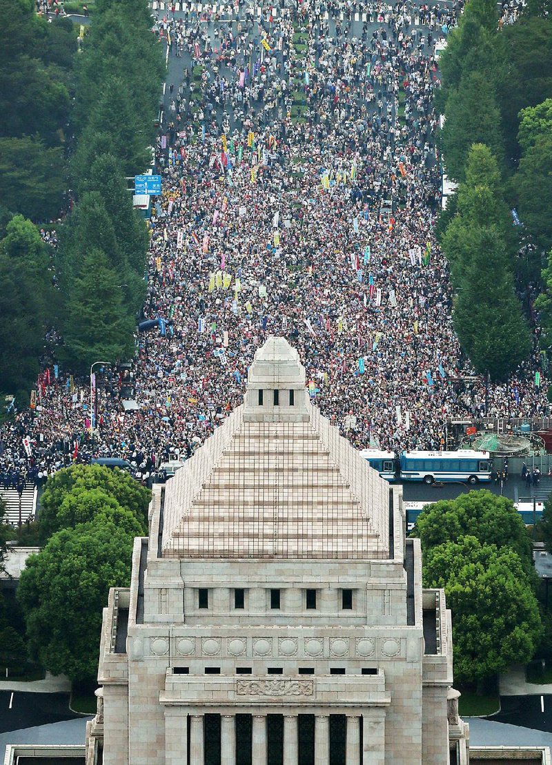 Protesters fill a street Sunday in front of the main gate of the National Diet building in Tokyo. Tens of thousands of people gathered outside Japan’s parliament to oppose security legislation.
