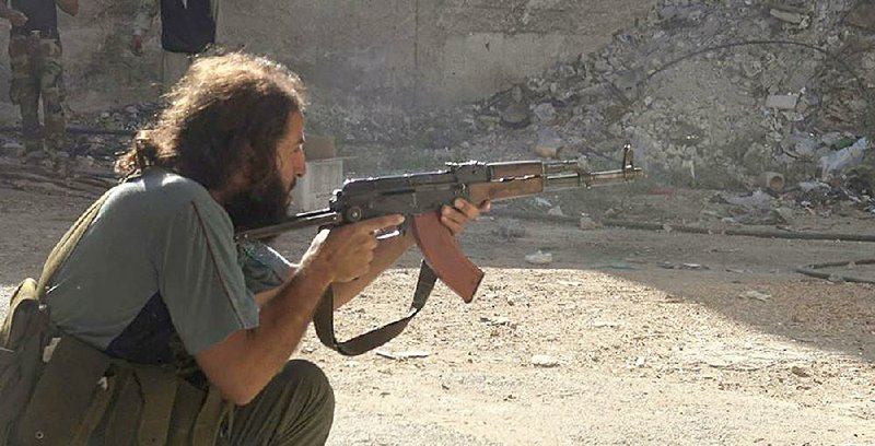 An Islamic State militant takes his position in an alley in the Qadam neighborhood of Damascus, Syria, in this photo released Sunday by the Rased News Network, a Facebook page affiliated with the Islamic State.