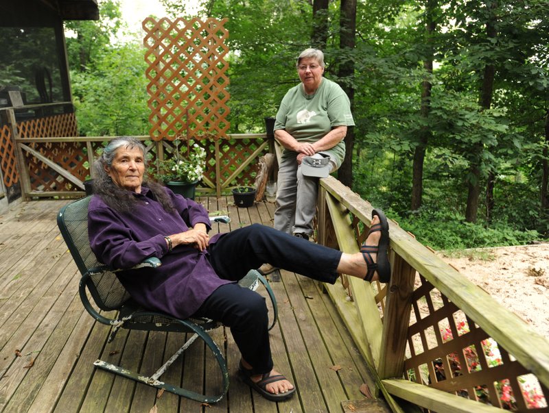 Diana Rivers (left) and Nancy Vaughn, seen Aug. 21, are both founding residents at the Ozark Land Holding Association in Madison County.