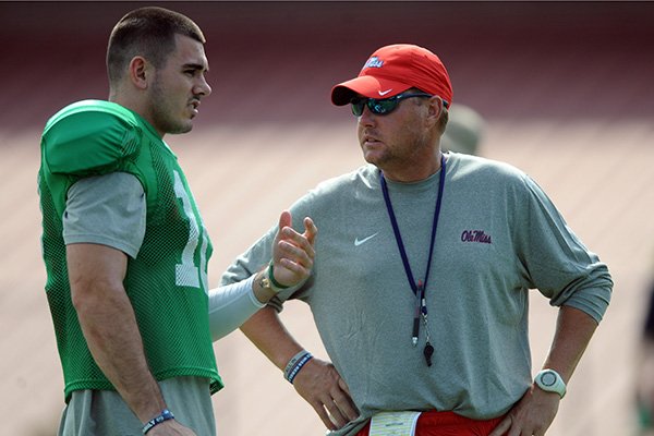 Mississippi quarterback Chad Kelly, left, talks with head coach Hugh Freeze during NCAA college football practice in Oxford, Miss., Monday, Aug. 10, 2015. (Bruce Newman/The Oxford Eagle via AP)