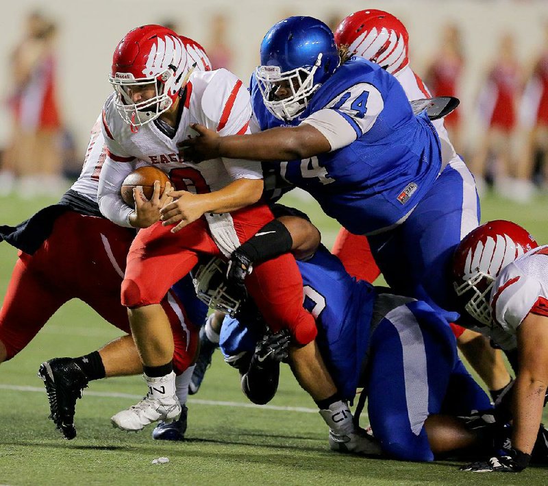 Vilonia quarterback Luke Gordon is sacked by Vonta Bens (74) and Devin Spencer of Sylvan Hills during Monday night's game. Gordon completed 18 of 35 passes for 167 yards and touchdown passes of 52 yards to Josh Greer and 7 yards to Tripp Reed in the second quarter of Sylvan Hills' 62-28 victory.