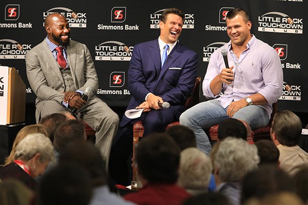 Felix Jones (from left) and David Bazzel laugh at a story told by Peyton Hillis at the Little Rock Touchdown Club luncheon in Little Rock on Monday, Aug. 31, 2015. All three played football for the University of Arkansas. Jones and Hillis, both former NFL players also, were the guest speakers and Bazzel was the host.