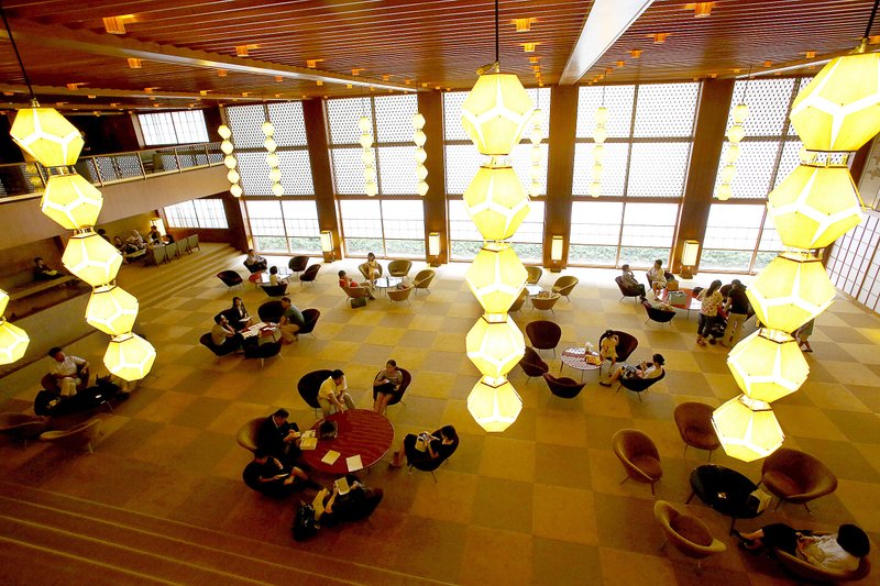 Visitors relax in the main lobby of the Hotel Okura in Tokyo. The hotel closed Monday to make way for a pair of towers being built to coincide with the 2020 Olympic Games.