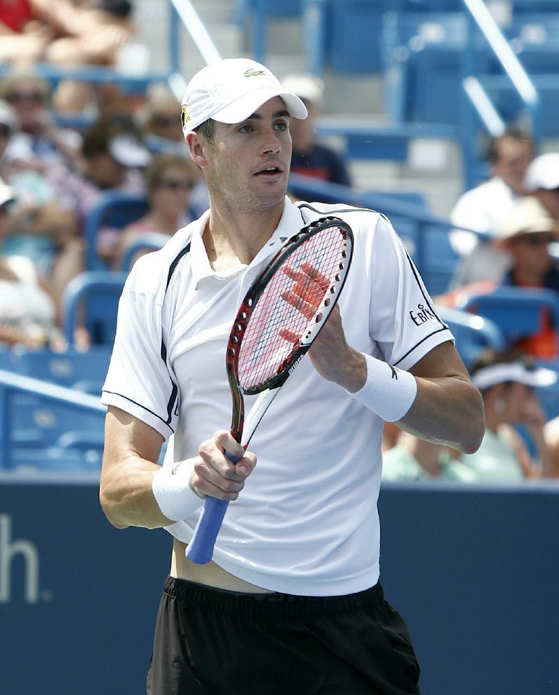 John Isner, of the United States, during a match with Sam Querrey, of the United States, at the Western & Southern Open tennis tournament, Tuesday, Aug. 18, 2015, in Mason, Ohio. 