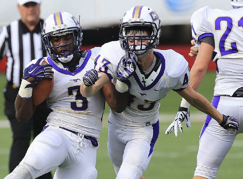 Central Arkansas Christian’s Zac Otwell (right) collides with teammate Braylon Harris as Harris carries the ball during Tuesday night’s game against Arkansas Baptist at War Memorial Stadium in Little Rock. More photos available at arkansasonline.com/galleries