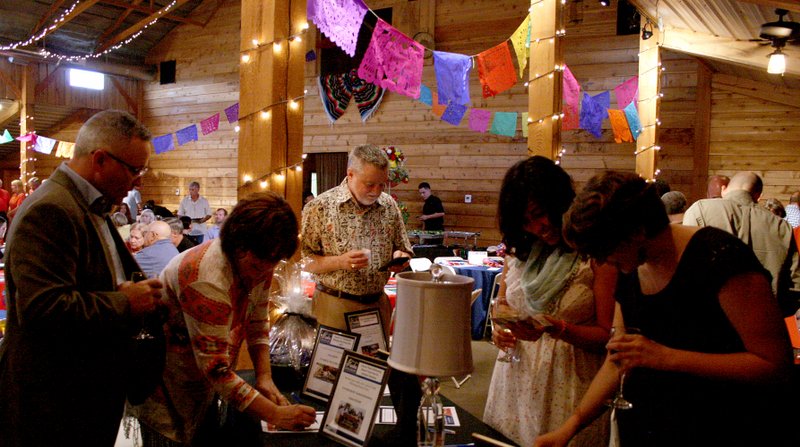 Landon Reeves/Herald-Leader More than 160 people attended the 10th annual Community Clinic fundraiser. Attendees placed bids on multiple items of art, food, decorations and services for the silent auction.