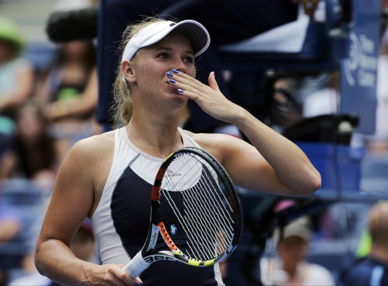 Caroline Wozniacki, of Denmark, blows kisses to the crowd after beating Jamie Loeb, of the United States, during the first round of the U.S. Open tennis tournament, Tuesday, Sept. 1, 2015, in New York.