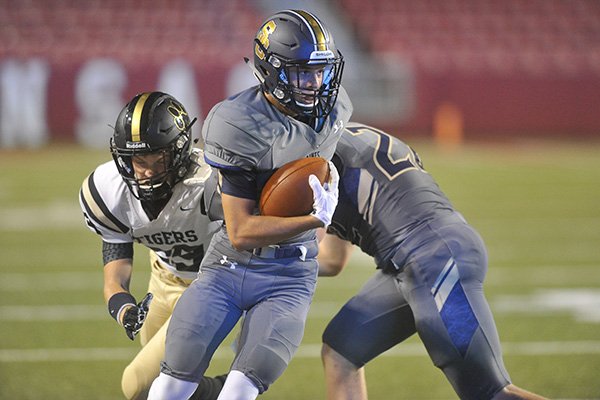 Shiloh Christian receiver Tyler Roth is pursued by Charleston defender Colton McDonald during a game Tuesday, Sept. 1, 2015, at Razorback Stadium in Fayetteville. 
