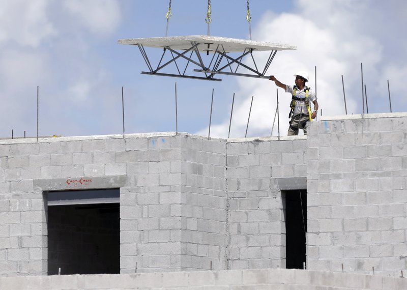 A construction worker guides material into place in August at the Landmark community, a group of condos and townhouses built by Lennar Homes in Doral, Fla. The Commerce Department said U.S. construction spending in July rose 0.7 percent to a seasonally adjusted annual rate of $1.08 trillion.