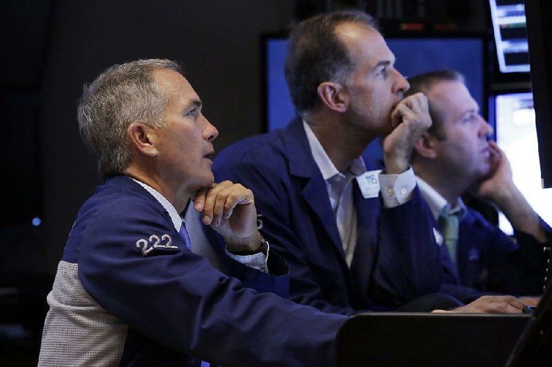 Traders work Wednesday on the floor of the New York Stock Exchange where stocks rallied almost 2 percent, recovering some of Tuesday’s losses. 