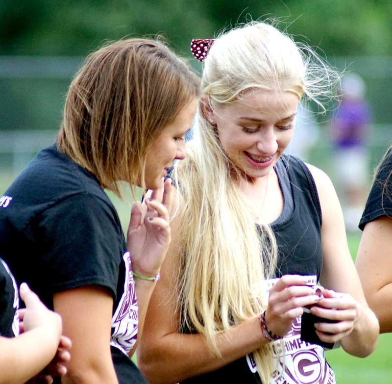 Photo by Randy Moll
Rachel Ward looks on and Amber Ellis smiles as they look at the rings presented to the Gentry High School girls' soccer team players for their state championship win in the 2015 season.