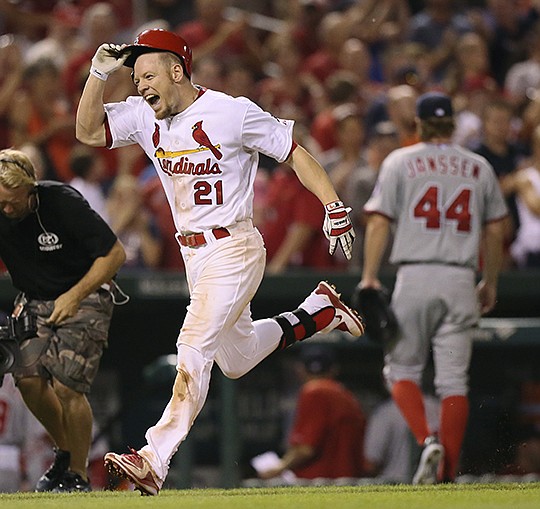 The Associated Press HEADED HOME: St. Louis' Brandon Moss grabs his helmet as he heads for home plate after hitting a walk-off, three-run home run off Washington's Casey Janssen (44) during the ninth inning Tuesday night in St. Louis. Moss' two-out homer gave the Cardinals a 8-5 win.