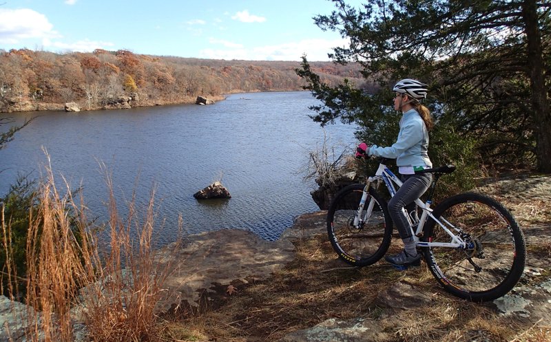 NWA Democrat-Gazette/FLIP PUTTHOFF Misty Murphy wears cycling gloves and a helmet during a November ride around Lincoln Lake.