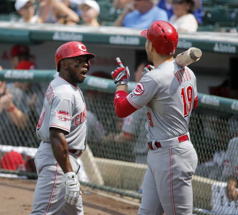 Cincinnati Reds' Jason Bourgeois, left, reacts with Joey Votto after Bourgeois hit a home run off Chicago Cubs starting pitcher Jason Hammel, during the first inning of a baseball game Wednesday, Sept. 2, 2015, in Chicago.