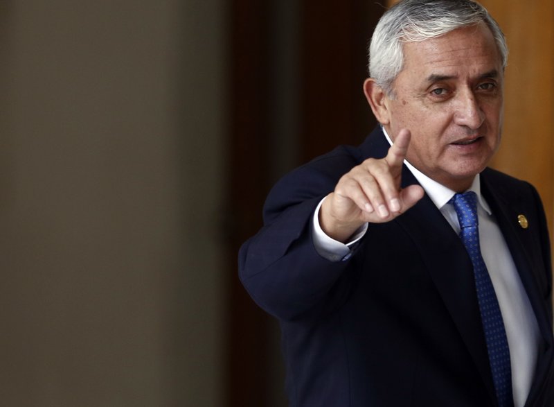 Guatemala's President Otto Perez Molina acknowledges reporters at the end of a press conference, in Guatemala City, Monday, Aug. 31, 2015.