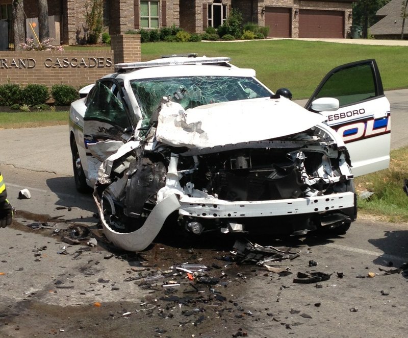 A Jonesboro police vehicle is visible at the scene of a two-car accident at Arkansas 351 and County Road 782 north of Jonesboro on Thursday, Sept. 3, 2015. 
