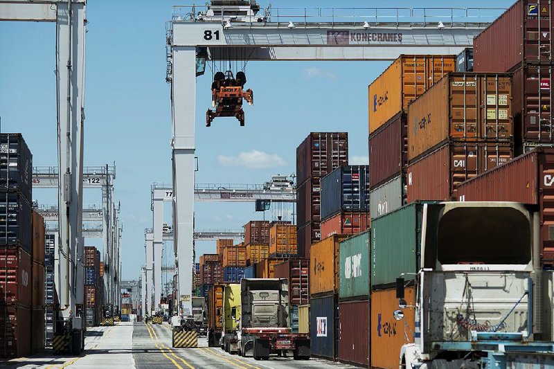 Trucks line up to be loaded with shipping containers last month at the Port of Savannah in Georgia. This year’s trade deficit is running above last year’s, reflecting weaker export sales. 