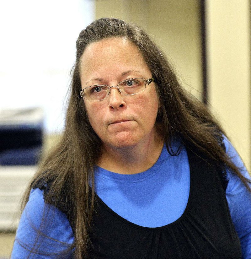 Rowan County Clerk Kim Davis listens to a customer following her office's refusal to issue marriage licenses at the Rowan County Courthouse in Morehead, Ky., Tuesday, Sept. 1, 2015. Although her appeal to the U.S. Supreme Court was denied, Davis still refuses to issue marriage licenses. 
