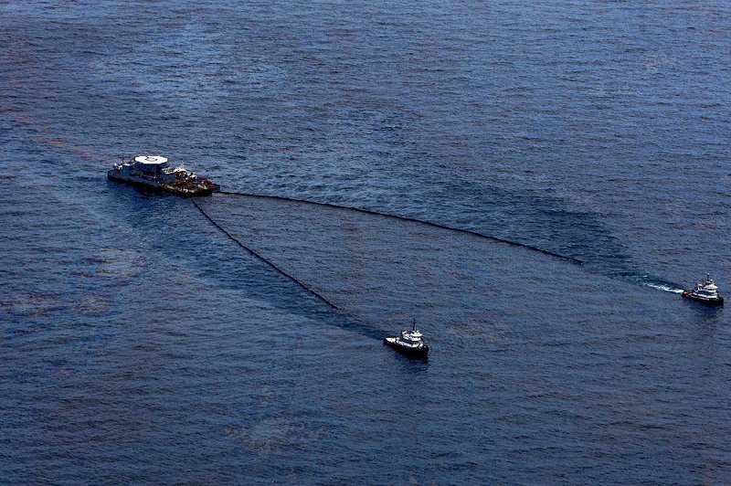 Ships skim oil from the water near the BP Deepwater Horizon oil spill in the Gulf of Mexico in June 2010. 