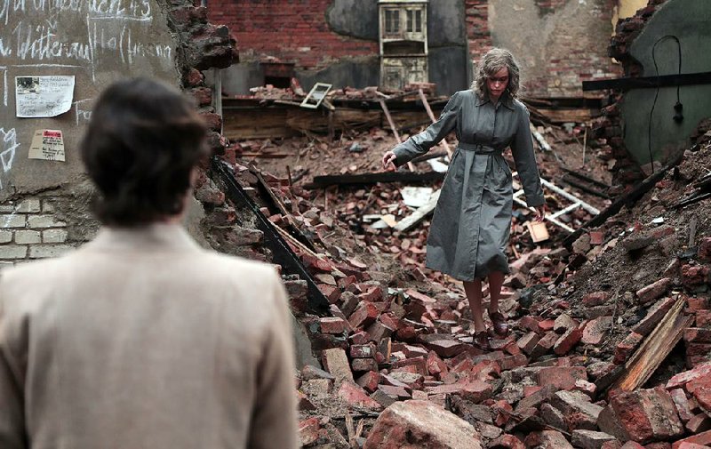 Nelly (Nina Hoss) inspects the ruins of her old Berlin apartment building in Phoenix, a German thriller set in the aftermath of the Holocaust.
