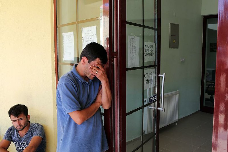 Abdullah Kurdi, father of Aylan, 3, and Galip, 5, waits outside a morgue Thursday in Mugla, Turkey, for the boys’ bodies to arrive from Bodrum, Turkey.