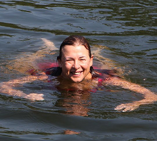 The Sentinel-Record/Richard Rasmussen TAKING A BREATHER: Open-water swimmer Jan Gerber, 62, of Hot Springs, takes a short break during her long distance swim from the Highway 70 west bridge to the Highway 7 south bridge on Lake Hamilton Thursday. She completed the swim in just under four hours, a distance of approximately 3.25 miles.