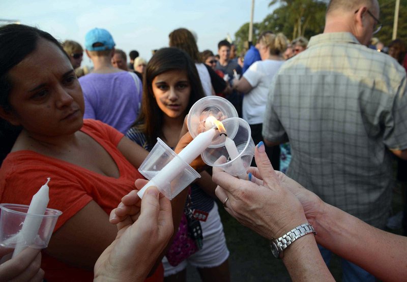 Mourners light candles during a vigil at Lakefront Park to honor  Lt. Charles Joseph Gliniewicz, Wednesday, Sept. 2, 2015, in Fox Lake, Ill. 