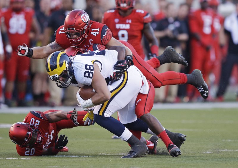 Utah linebacker Jared Norris (41) tackles Michigan tight end Jake Butt (88) in the first quarter during an NCAA college football game, Thursday, Sept. 3, 2015, in Salt Lake City.