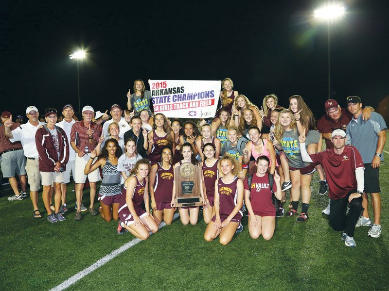  Members and coaches of the 2014-2015 Lake Hamilton Lady Wolves track team celebrate the team’s 2015 Class 6A State Championship with the title banner.