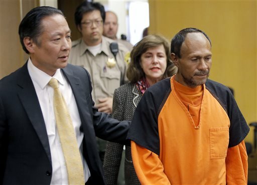 In this July 7, 2015, file photo, Juan Francisco Lopez-Sanchez, right, is led into the courtroom by San Francisco public defender Jeff Adachi, left, and Assistant District Attorney Diana Garciaor, center, for his arraignment at the Hall of Justice in San Francisco.