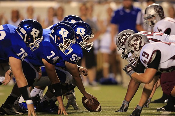 Bryant, left, and Benton players line up for a snap during their game Sept. 5, 2014, at War Memorial Stadium in Little Rock. 